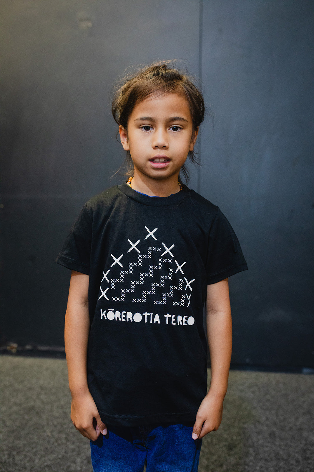 Kainga Korerotia Te Reo Print Child Tee - Black